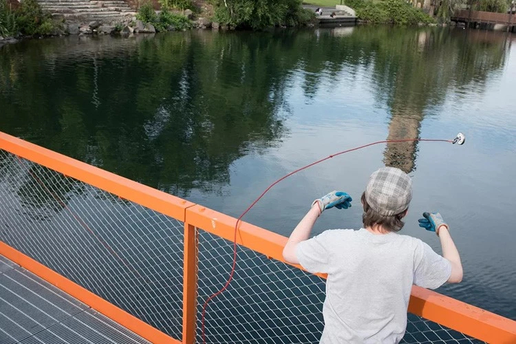 Fishing magnet fishermen display their skills on the bridge Fishing magnet fishermen display their skills on the bridge